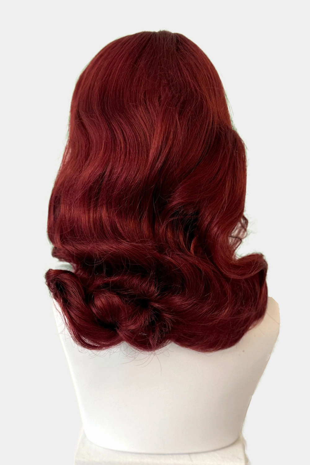 Copper red 1950s pinup wig, curled with short fringe: Kitty